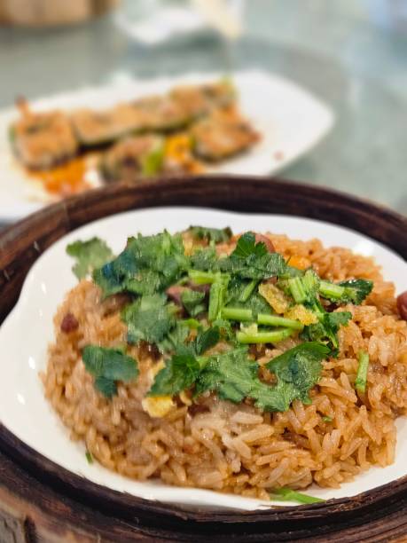 Hong Kong Restaurant - Stir-fried Glutinous Rice (生炒糯米飯) is a savory, hearty, and versatile dish that is loved for its chewy texture and ability to absorb rich, umami-filled seasonings. The glutinous rice provides a satisfying base, and when combined with meats, vegetables, and a blend of flavorful seasonings, it becomes a delicious and comforting dish perfect for any meal. Whether enjoyed in a family-style dinner or as part of a dim sum spread, stir-fried glutinous rice is always a crowd-pleaser.