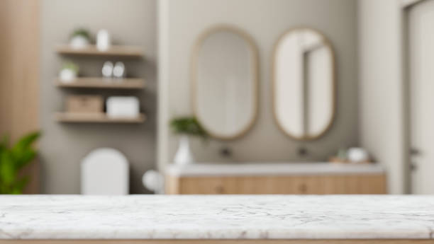 istock A white marble tabletop set against a blurred background of a modern bathroom. 2184460085