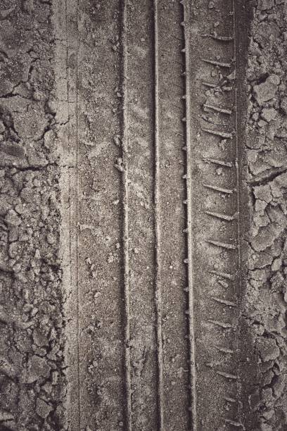 istock Wheel tracks on the soil road background or texture 2184462341