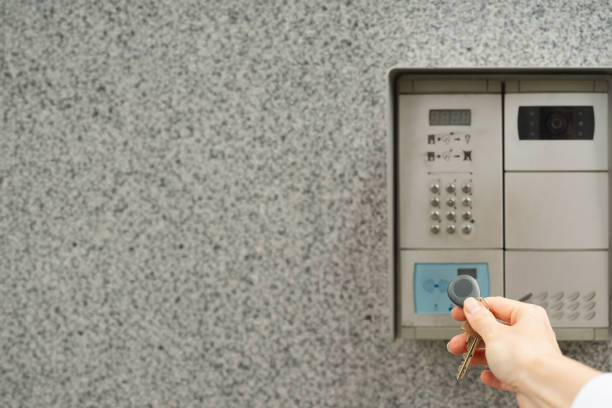 istock Woman's hand with key fob against intercom 2184462538