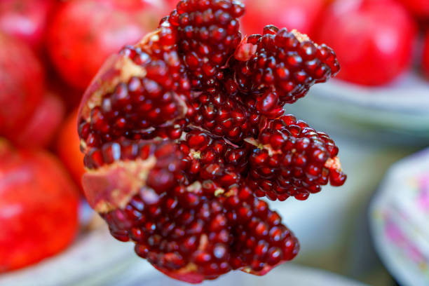 A close up of a red pomegranate with a few seeds missing in Tashkent, Uzbekistan