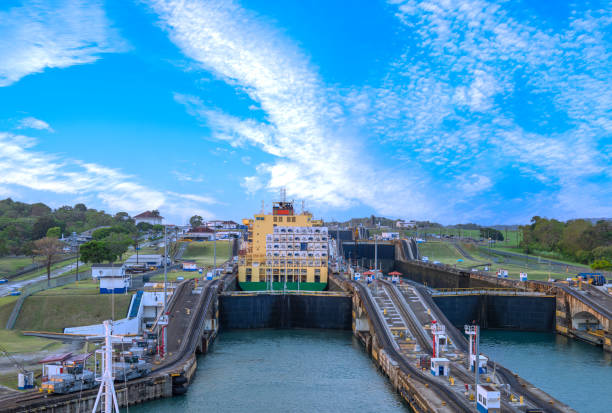 Conatiner ship descending to sea level at the news locks of the Panama Canal at Agua Clara on the Atlantic/Caribbean side, ColÃ³n, Panama. The Atlantic Birdge can be seen in the background.