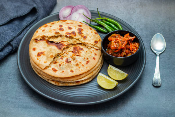 istock Sattu paratha, a popular stuffed flatbread from Uttar Pradesh and Bihar, is hearty, nutritious, and traditionally served with pickle and raita. 2184475590
