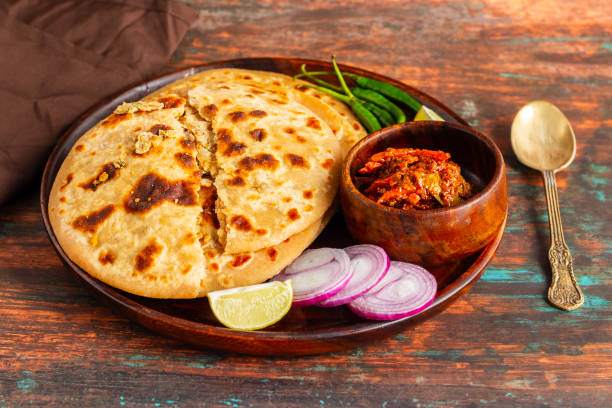 istock Sattu paratha, a popular stuffed flatbread from Uttar Pradesh and Bihar, is hearty, nutritious, and served with pickle and raita. 2184475683