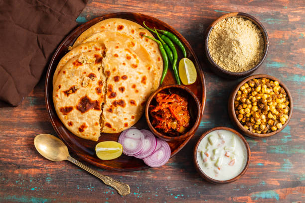 istock Sattu paratha, a nutritious flatbread stuffed with roasted gram flour, is popular in Uttar Pradesh and Bihar, served with pickle and raita. 2184475747