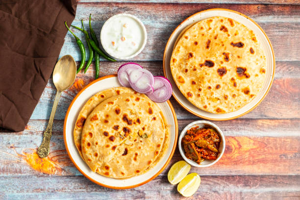 istock Sattu paratha, a popular stuffed flatbread from Uttar Pradesh and Bihar, is hearty, nutritious, and served with pickle and raita. 2184475846
