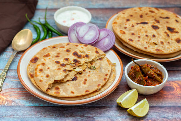 istock Sattu paratha, a nutritious flatbread stuffed with roasted gram flour, is popular in Uttar Pradesh and Bihar, served with pickle and raita. 2184475848