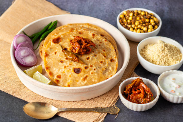 istock Sattu paratha, a nutritious flatbread stuffed with roasted gram flour, is popular in Uttar Pradesh and Bihar, served with pickle and raita. 2184476057