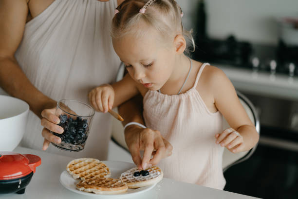 istock Mother and daughter preparing food in kitchen 2184483389