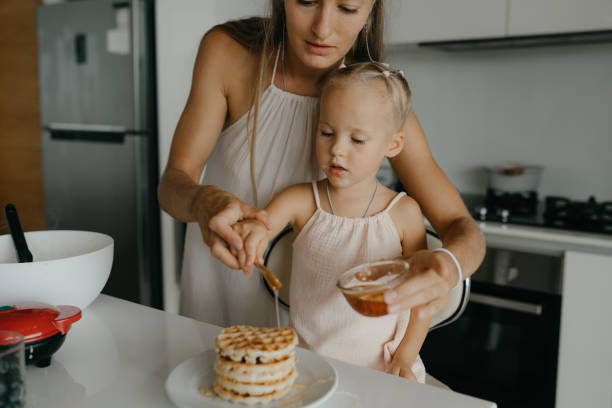 istock Mother and daughter preparing food in kitchen 2184483467