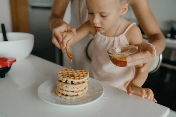 istock Mother and daughter preparing food in kitchen 2184483471