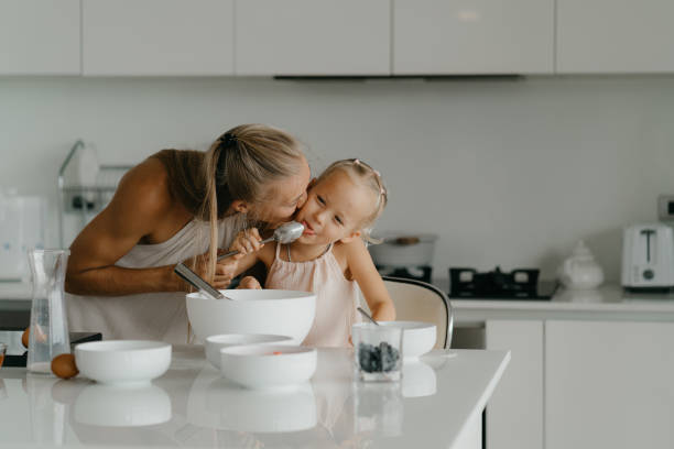 istock Mother and daughter having fun in kitchen 2184483878
