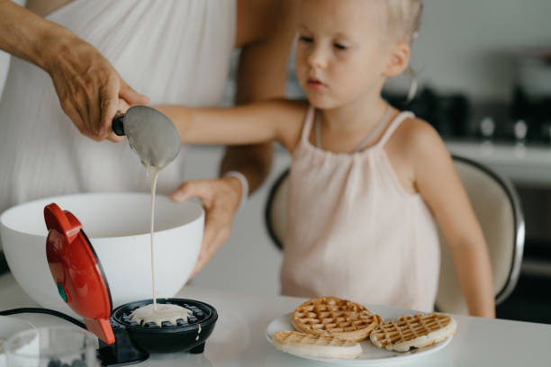 istock Mother and daughter preparing food in kitchen 2184483938