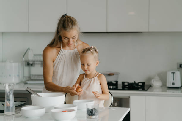 istock Mother and daughter preparing food in kitchen 2184484690
