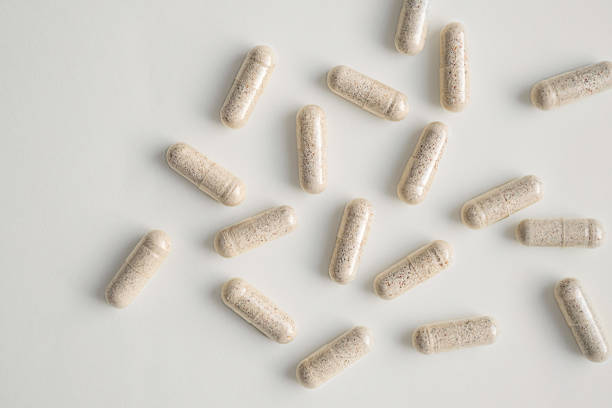istock Vitamin capsules scattered on light surface. Health and wellness concepts. 2184485841