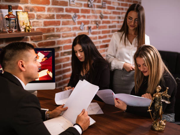 istock Lawyer Discussing Case with Clients at the Office 2184486016