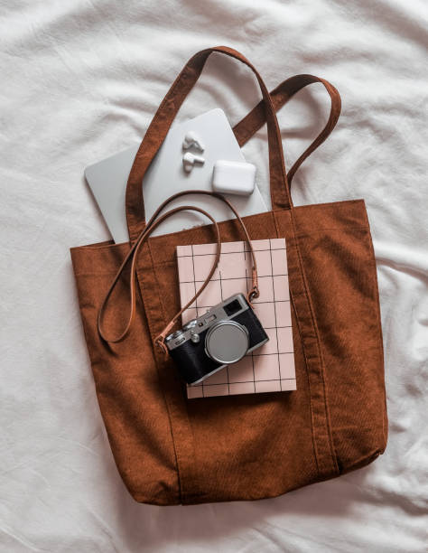 istock Brown corduroy shopper, laptop, notebook, camera on a light background, top view 2184486831