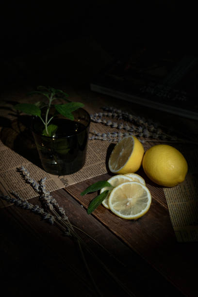 Cut and intact lemon on the desktop in a dark environment
