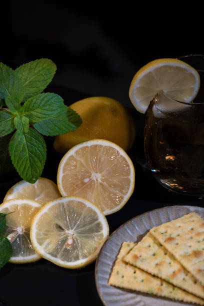 Cut and intact lemon on the desktop in a dark environment