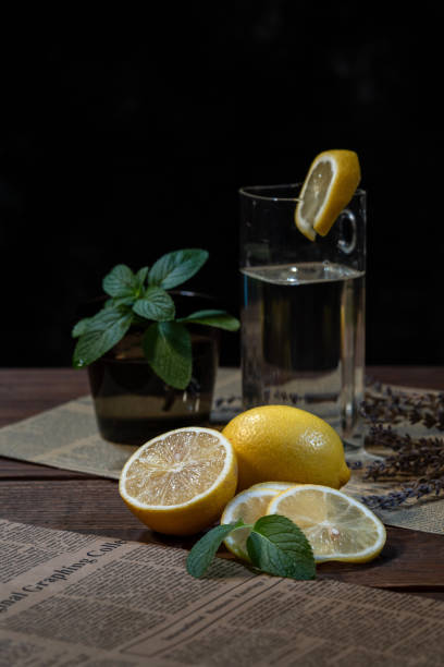 Cut and intact lemon on the desktop in a dark environment