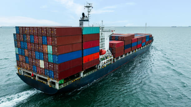 istock Aerial rear view Container Ship load container going to seaport or unload at container warehouse on the green sea. Logistics, import export, shipping or transportation Asia Pacific 2184489804