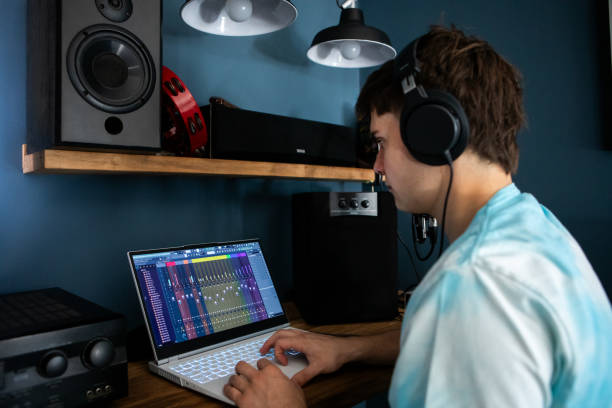 istock Young man producing music in his home recording music studio 2184490216