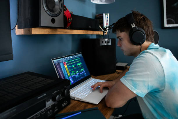 istock Young man producing music in his home recording music studio 2184490221