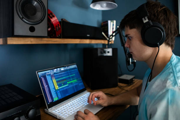 istock Young man producing music in his home recording music studio 2184490222