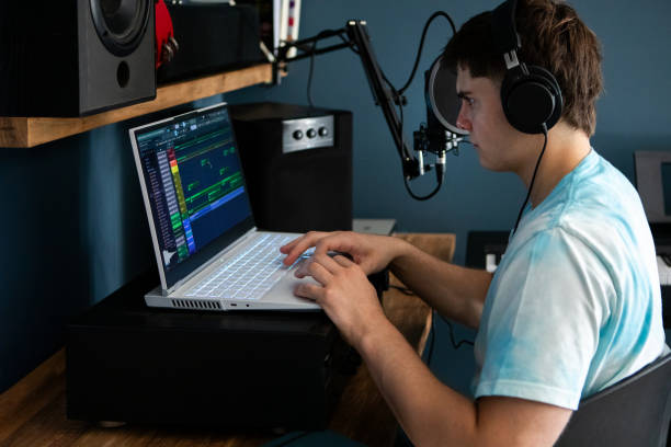 istock Young man producing music in his home recording music studio 2184490265