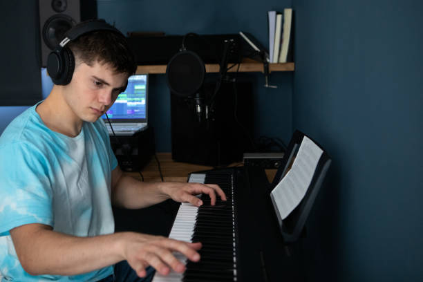 istock Young man producing music in his home recording music studio 2184490293