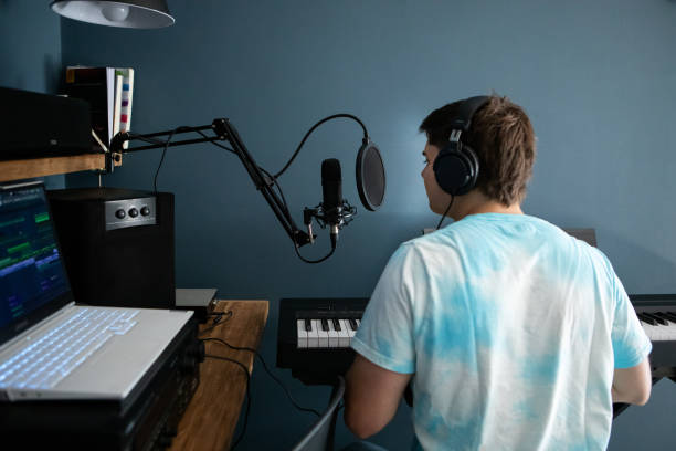 istock Young man producing music in his home recording music studio 2184490361