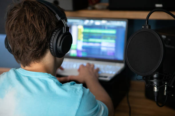 istock Young man producing music in his home recording music studio 2184490392