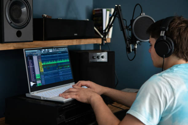 istock Young man producing music in his home recording music studio 2184490478