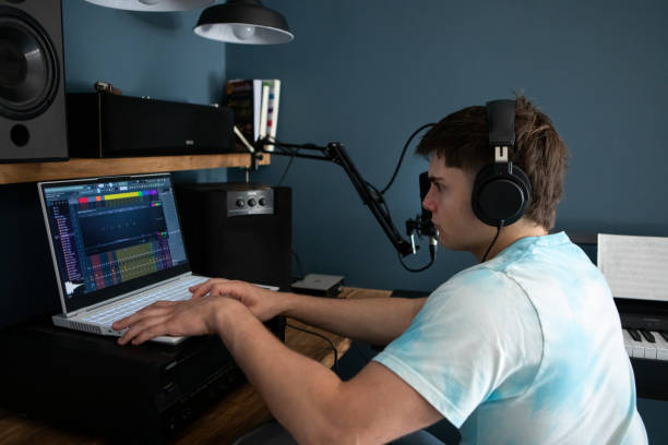 istock Young man producing music in his home recording music studio 2184490480
