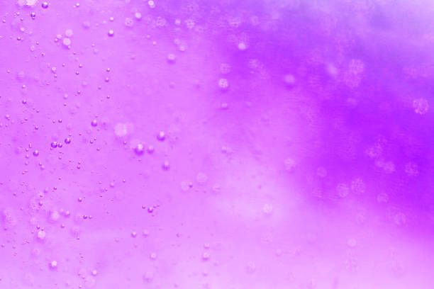 surface of oil or serum with bubbles. festive cosmetic background. Blurred background