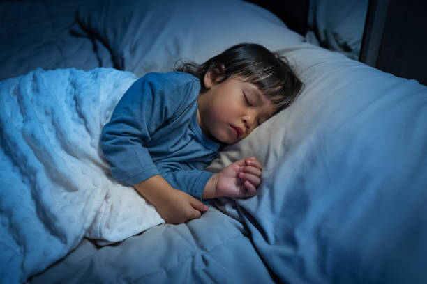 istock toddler baby sleeping on bed at night 2184493959