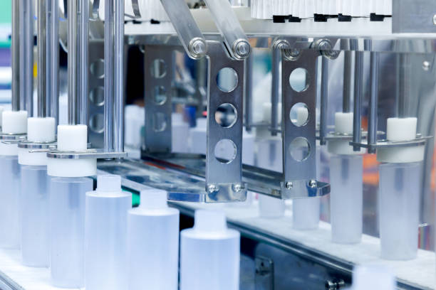 istock robot arm moving plastic bottle to conveyor belt of auto capping and labeling machine at cosmetic and skin care manufacturing. cosmetic industry and ai technology machinery concept. 2184494696