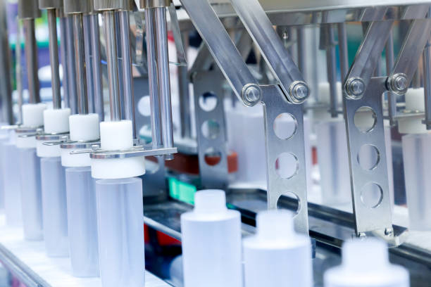 istock robot arm moving plastic bottle to conveyor belt of auto capping and labeling machine at cosmetic and skin care manufacturing. cosmetic industry and ai technology machinery concept. 2184494700