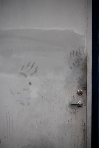 istock A gray door with scary hand marks on it 2184495912