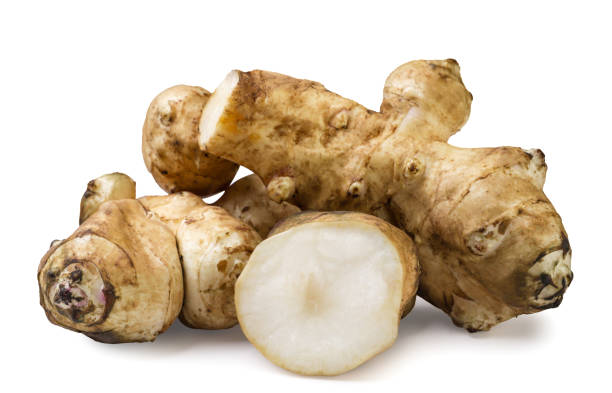 istock Jerusalem artichoke and a piece on a white background. Isolated 2184496859