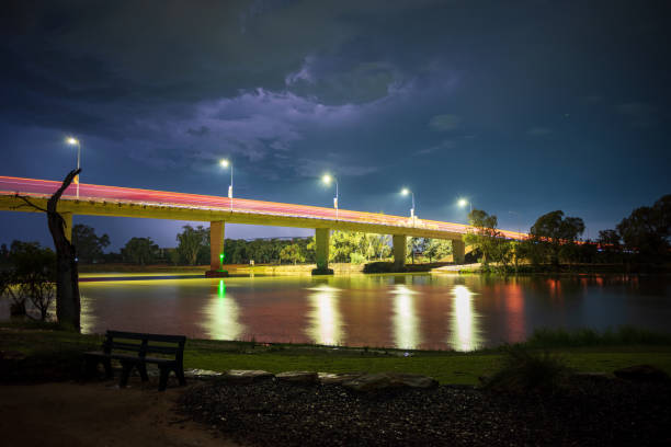 istock Serene Nightscape Featuring Light Trails of Vehicles Passing Over a Bridge Spanning the Murray River, as a storm looms overhead. Mildura, Victoria. 2184500823