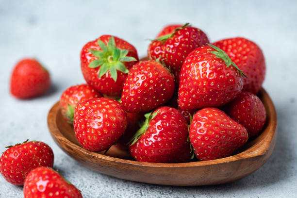 istock Strawberries in a wooden bowl 2184501046