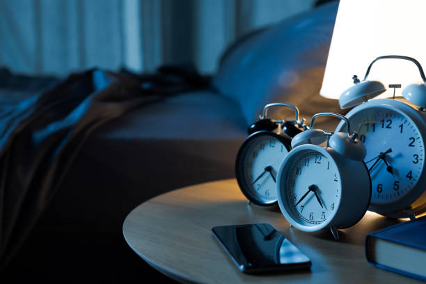istock Many alarm clocks on the bedside table 2184503100