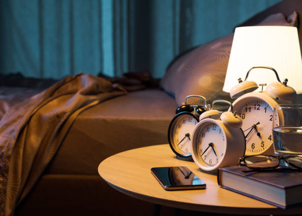istock Many alarm clocks on the bedside table 2184503192