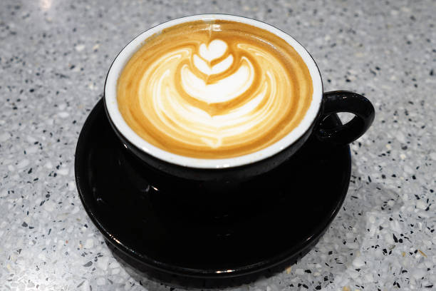 istock Close up black ceramic cup of hot Latte coffee art 2184504790
