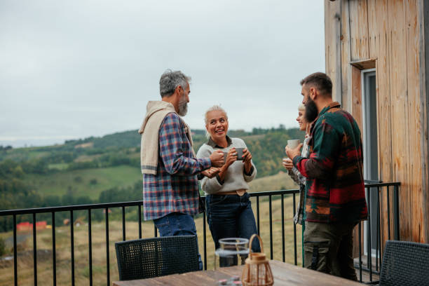 istock Joyful friends socializing at mountain cabin. 2184504996