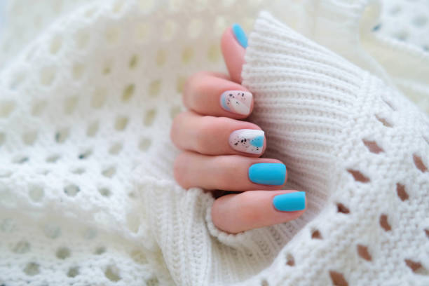 istock Beautiful summer manicure. Nail design with blue pattern. 2184505878