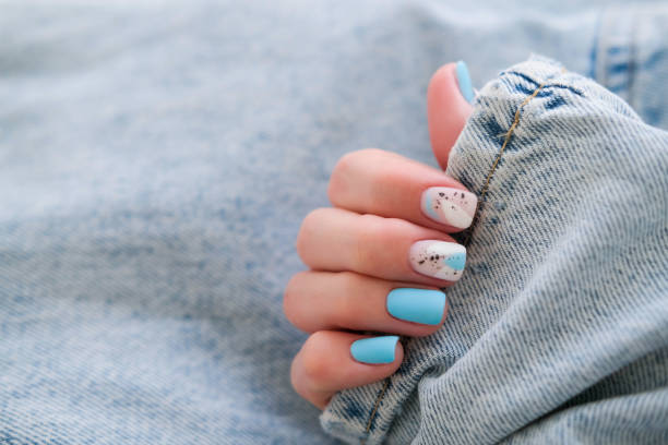 istock Beautiful summer manicure. Nail design with blue pattern. 2184505879