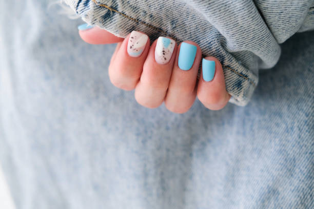 istock Beautiful summer manicure. Nail design with blue pattern. 2184505880