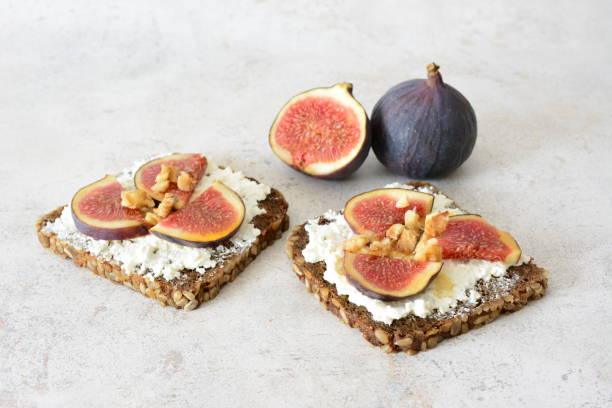 istock a square slice of wholegrain bread with figs and nuts on top 2184506942